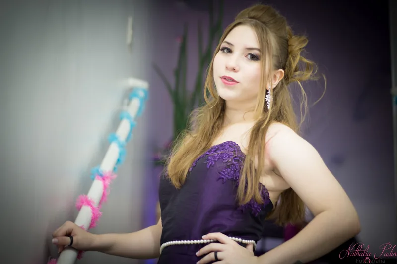 Debutante com vestido roxo e maquiagem de festa
